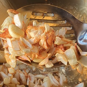 An image of roasted onions and garlic cloves